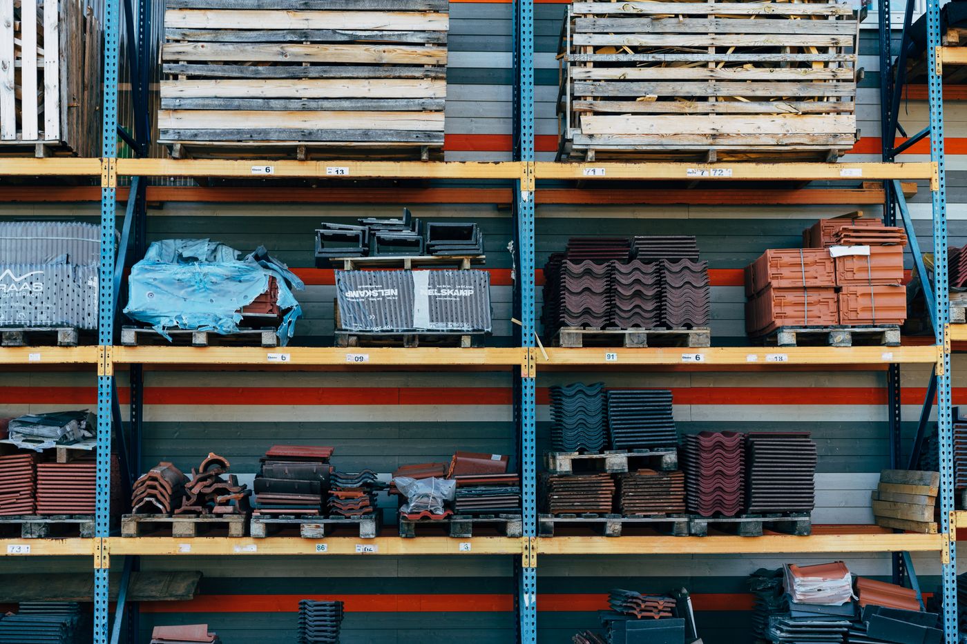 Building materials organized on warehouse shelves